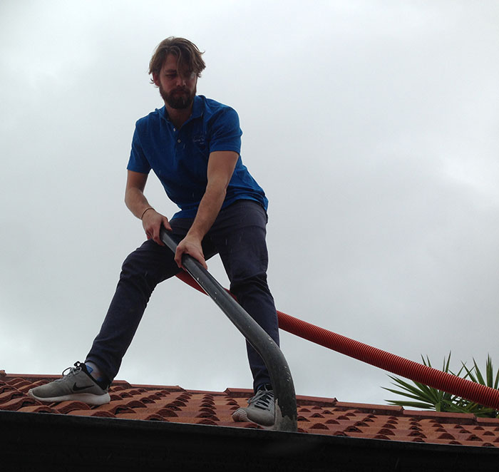 Gutter cleaner vacuuming gutters